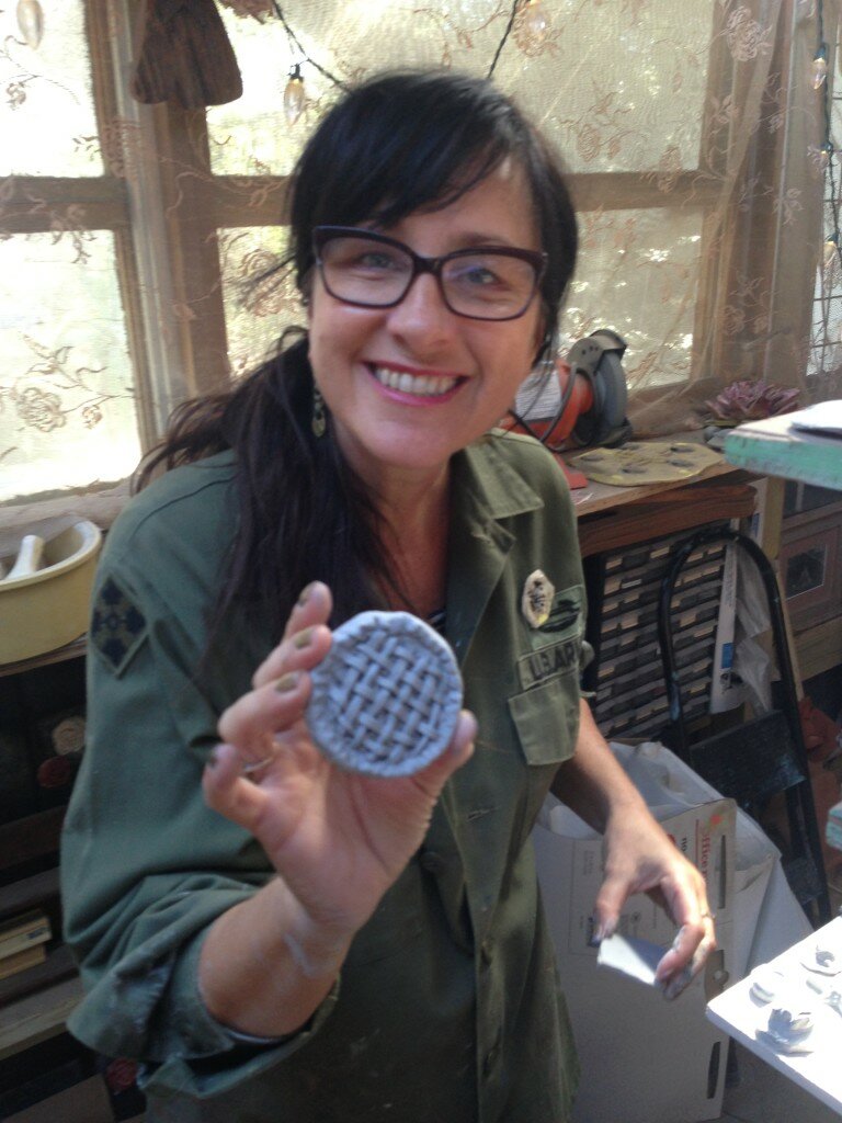 Mosaic artist Stefanie Distefano holds a pie tile made by a friend of Monroe's.