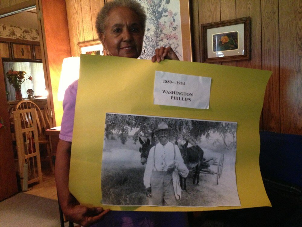 Doris Nealy holds a poster of her former neighbor.